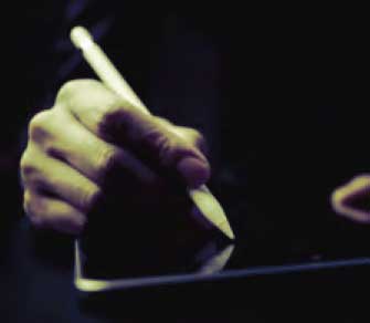Photo: Hand holding tablet stylus